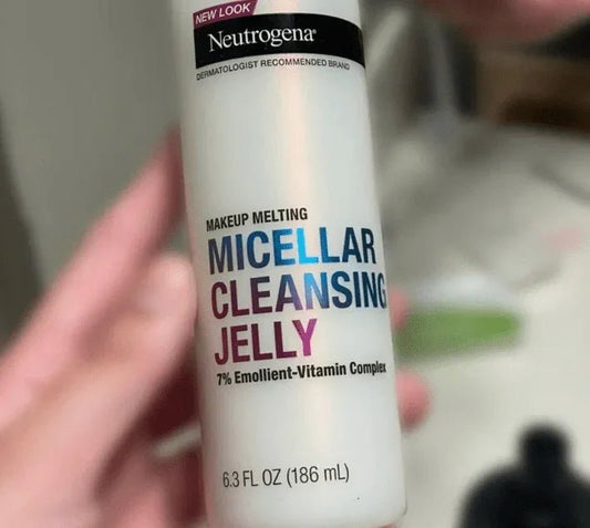 Hand holding Neutrogena Makeup Melting Micellar Cleansing Jelly 6.3 fl oz skincare bottle