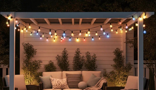 Outdoor patio with LED string lights, cozy seating area, and plants at night