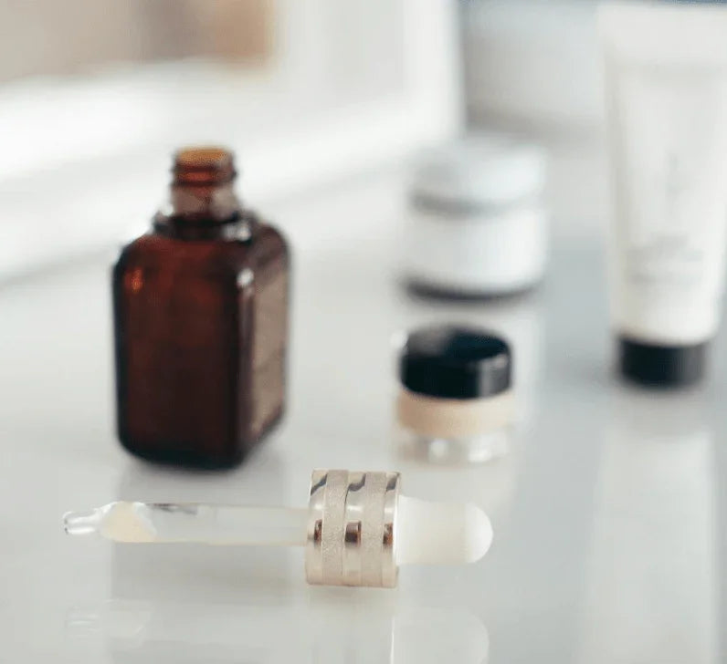 Affordable skincare products, serum dropper, and cream jars on a clean white surface