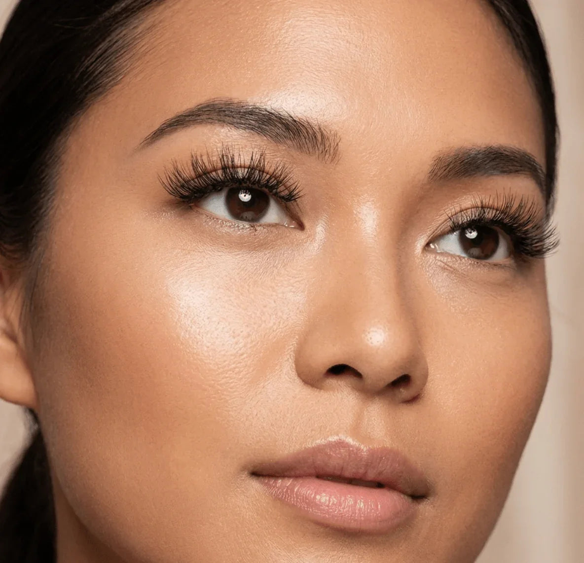 Close-up of woman wearing natural wispy false eyelashes for a full, voluminous look.