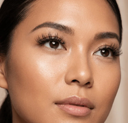 Close-up of woman wearing natural wispy false eyelashes for a full, voluminous look.