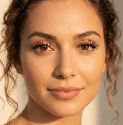 Woman wearing natural wispy false eyelashes, close-up beauty makeup look