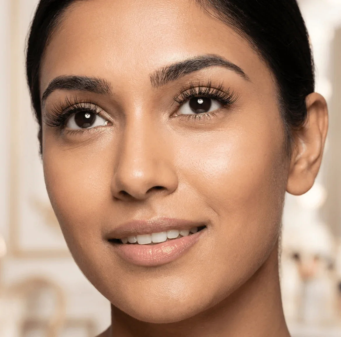 Woman wearing natural wispy false eyelashes, close-up of eyes and lashes