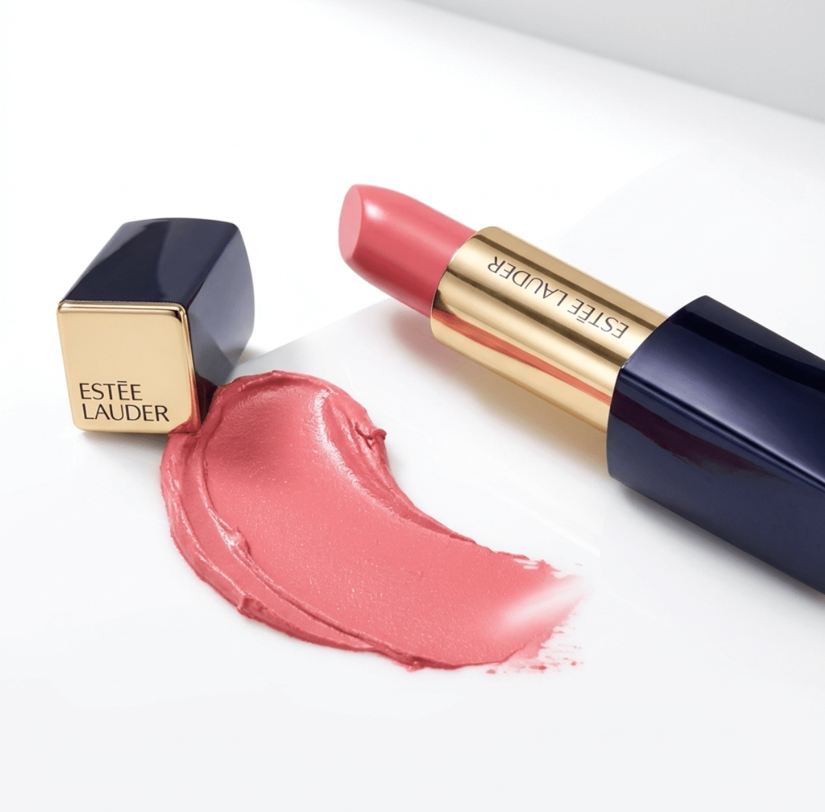 Estée Lauder lipstick with pink shade on a white background