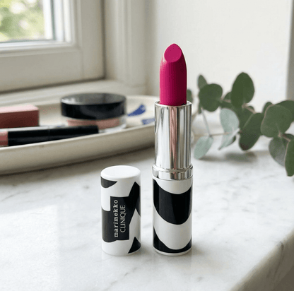 Lipstick with black and white patterned case on a marble surface